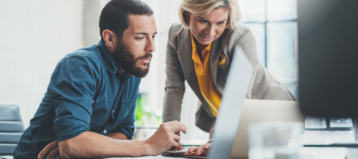 two people working on laptop