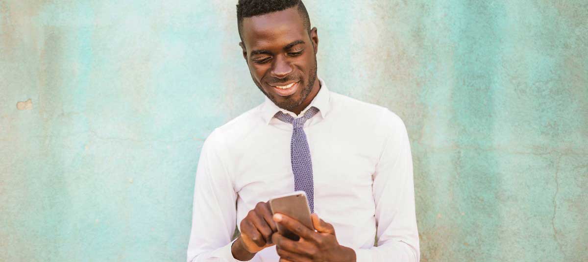 Man in a shirt and tie scrolling social media