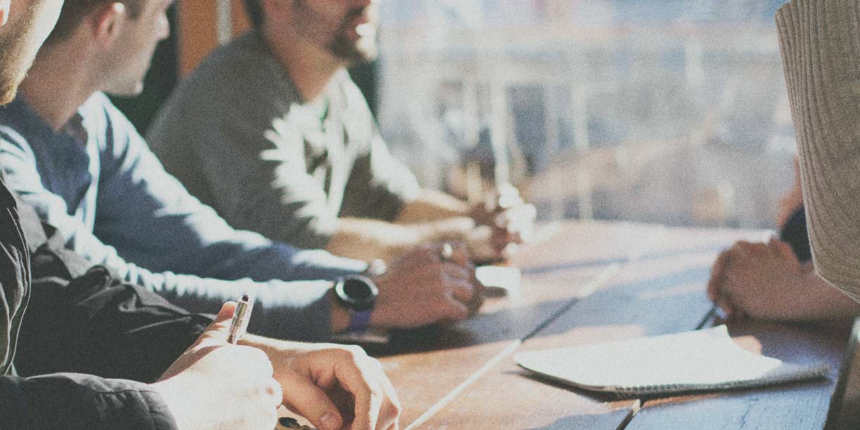 Employees sitting at a table for a meeting