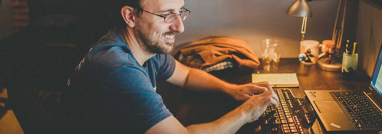 man smiling on computer