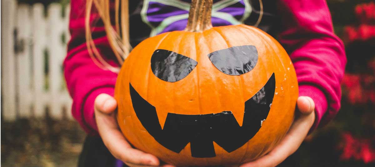 girl holding a pumpkin