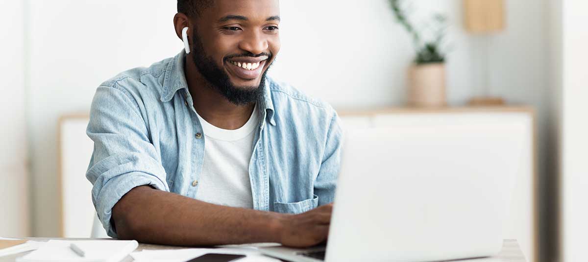 happy person typing on computer