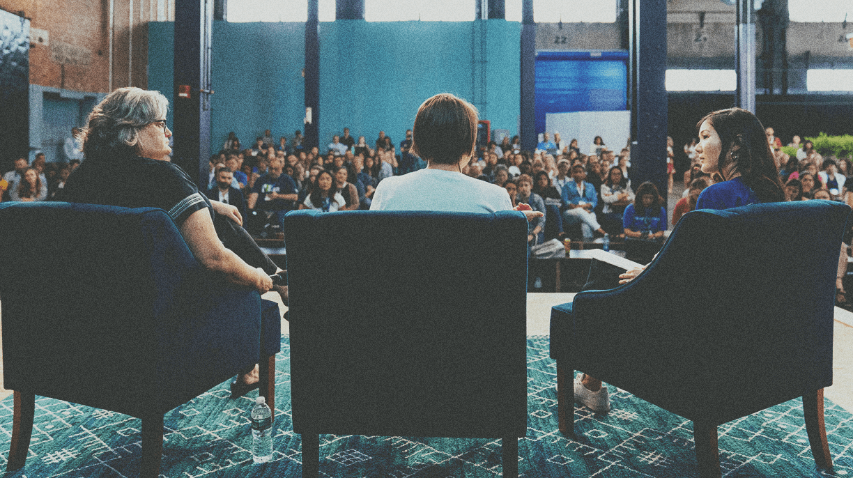 3 people speaking at a conference