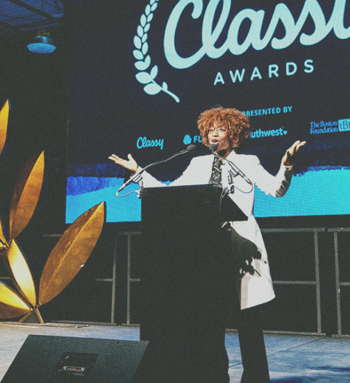 Photo of woman at a podium speaking at the Classy awards
