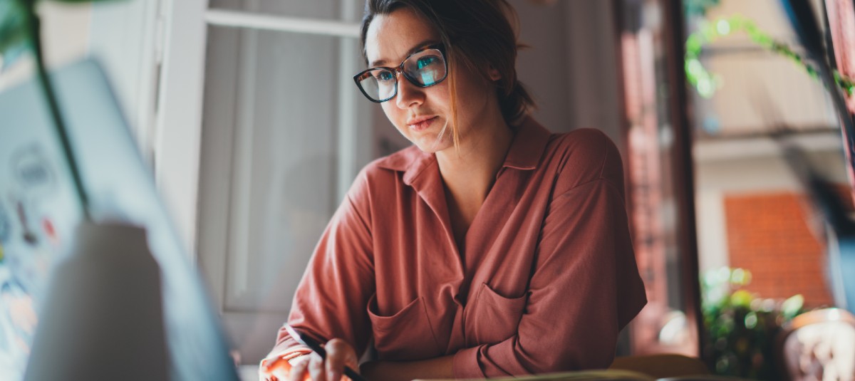 woman writing emails on her laptop