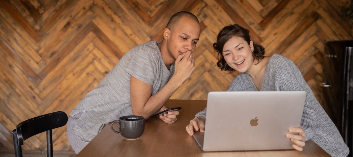 two people staring at laptop