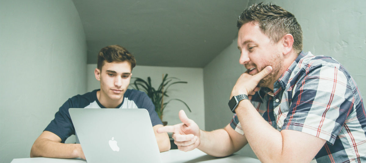 Guys talking about whats on their laptop