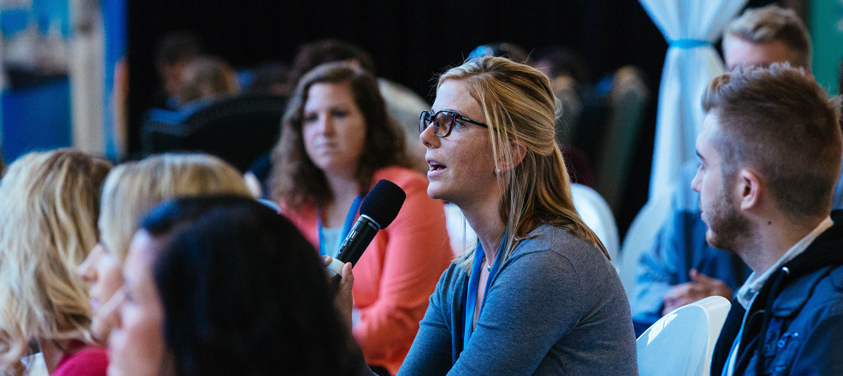 woman speaking in large crowd