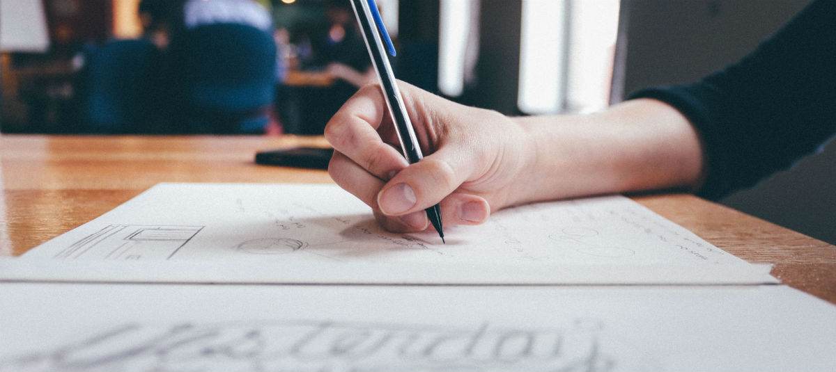 woman writing on a piece of paper