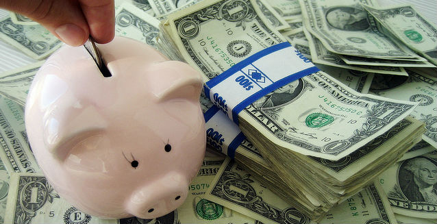 piggy bank holder and dollar bills