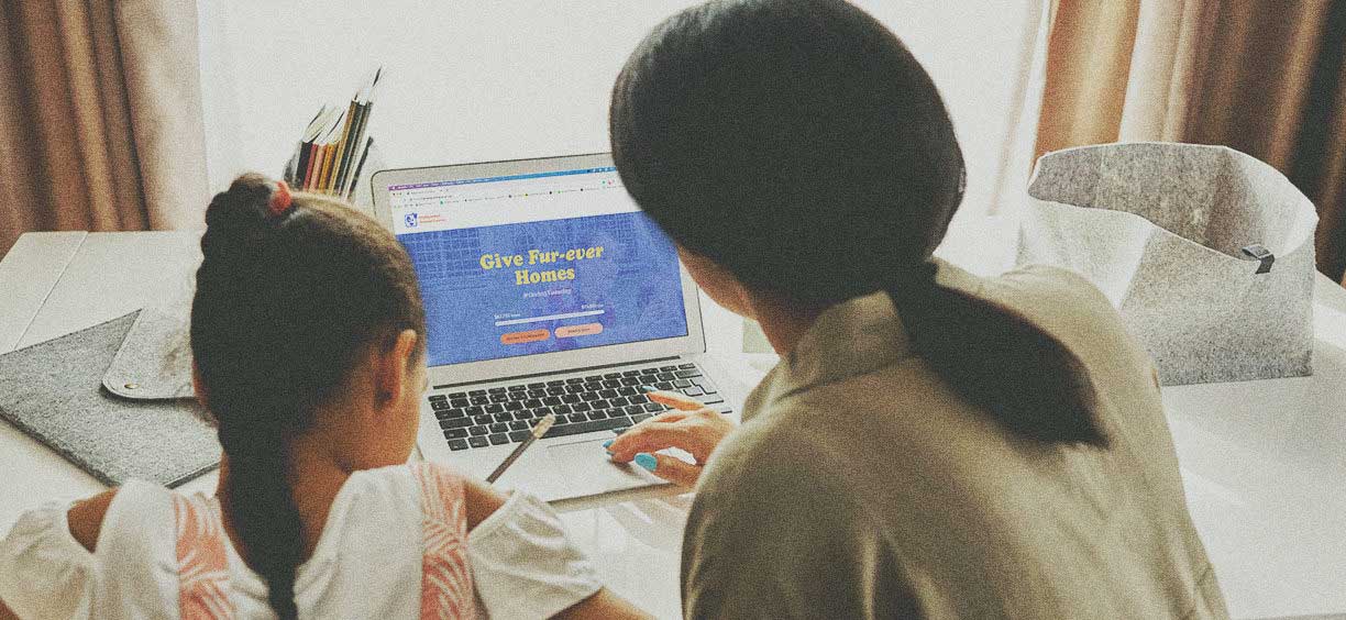 mother and daughter searching fall fundraising ideas on laptop