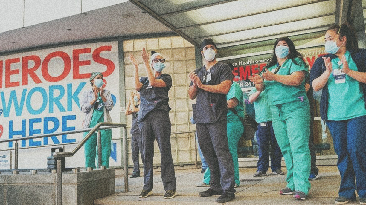 healthcare workers standing outside hospital doors