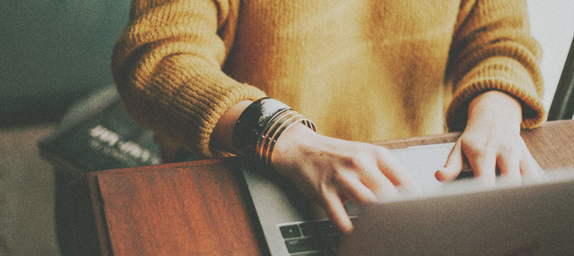 yellow shirt woman typing