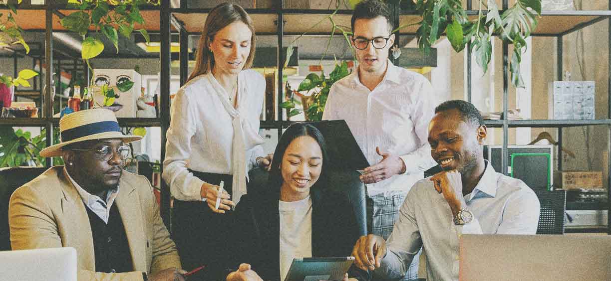 5 people working together on computers