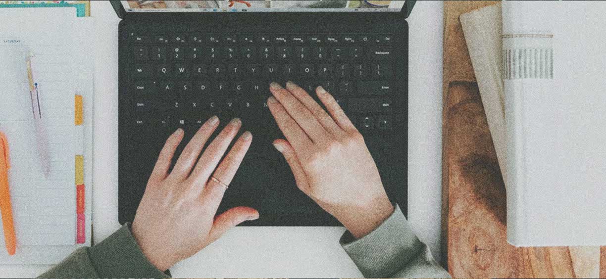 hands typing on keyboard