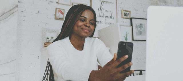 girl in white holding cell phone