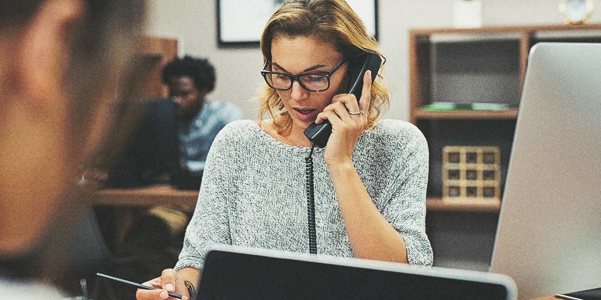 woman in gray on telephone