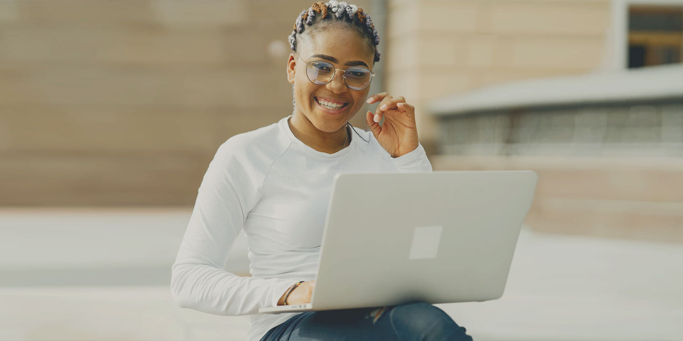 girl in white on laptop