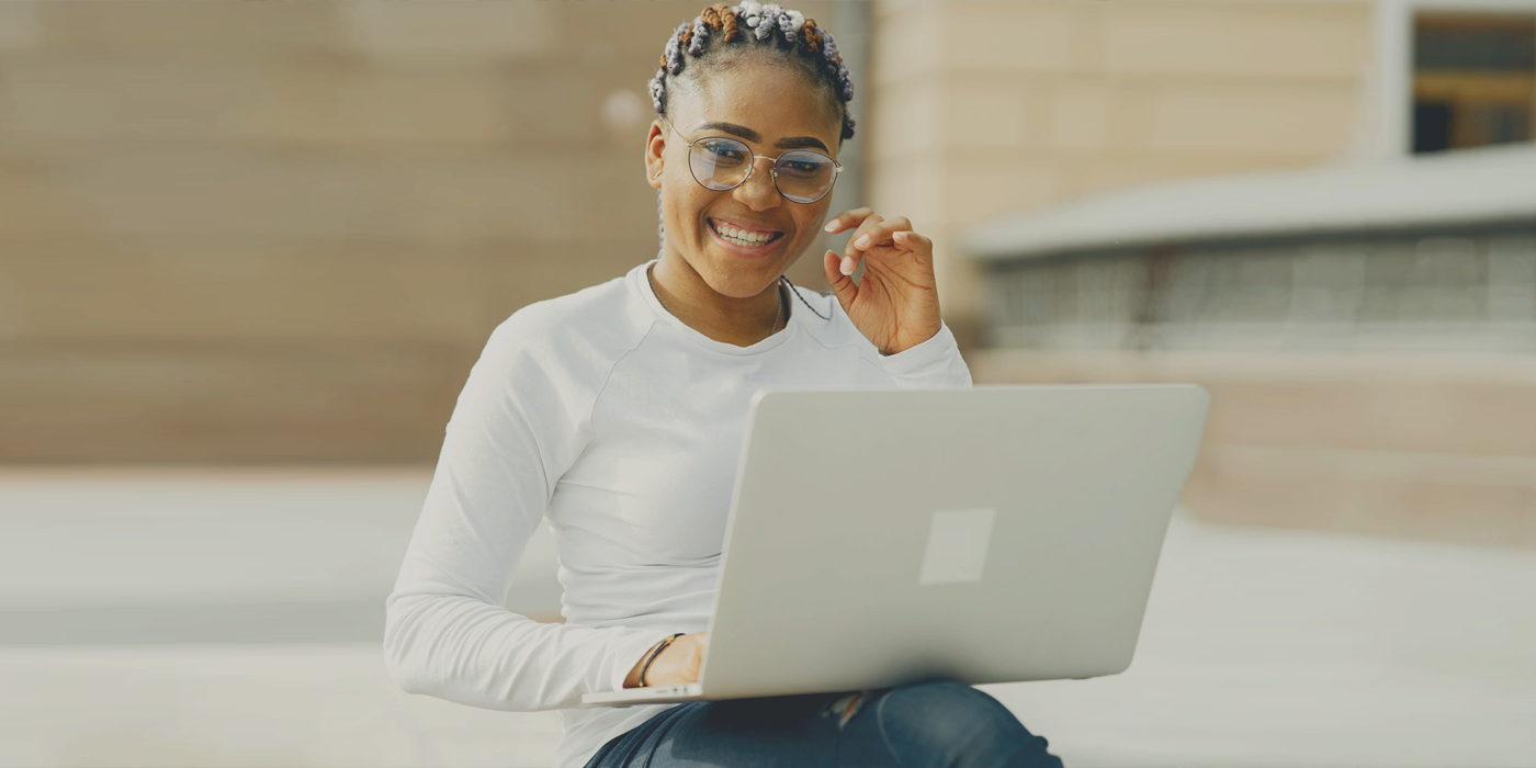 Girl in white filling out 501c3 nonprofit forms on her laptop