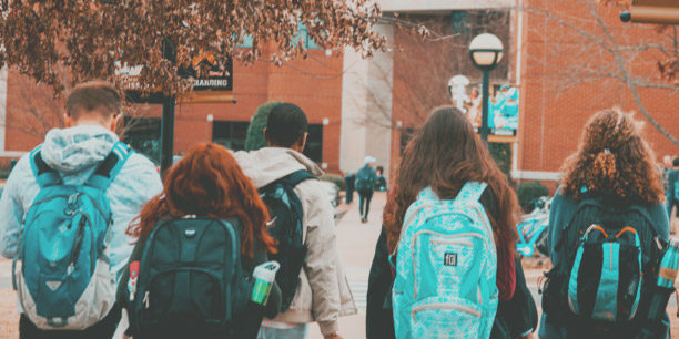 kids walking to school with backpacks on