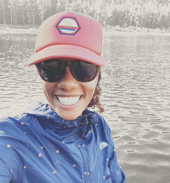 Selfie of smiling woman by a lake