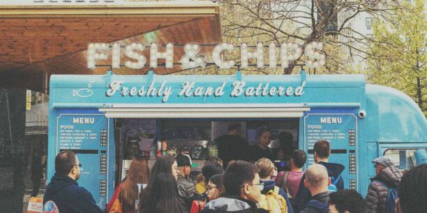 Blue Fish & Chips food truck parked outside serving customers