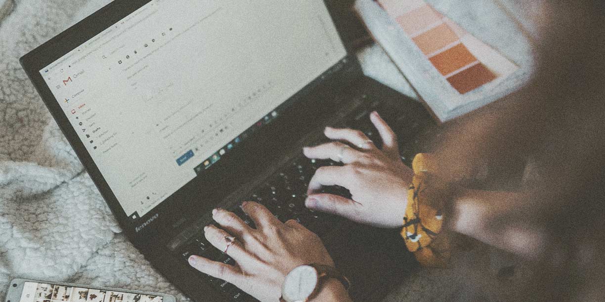 Person typing on black laptop