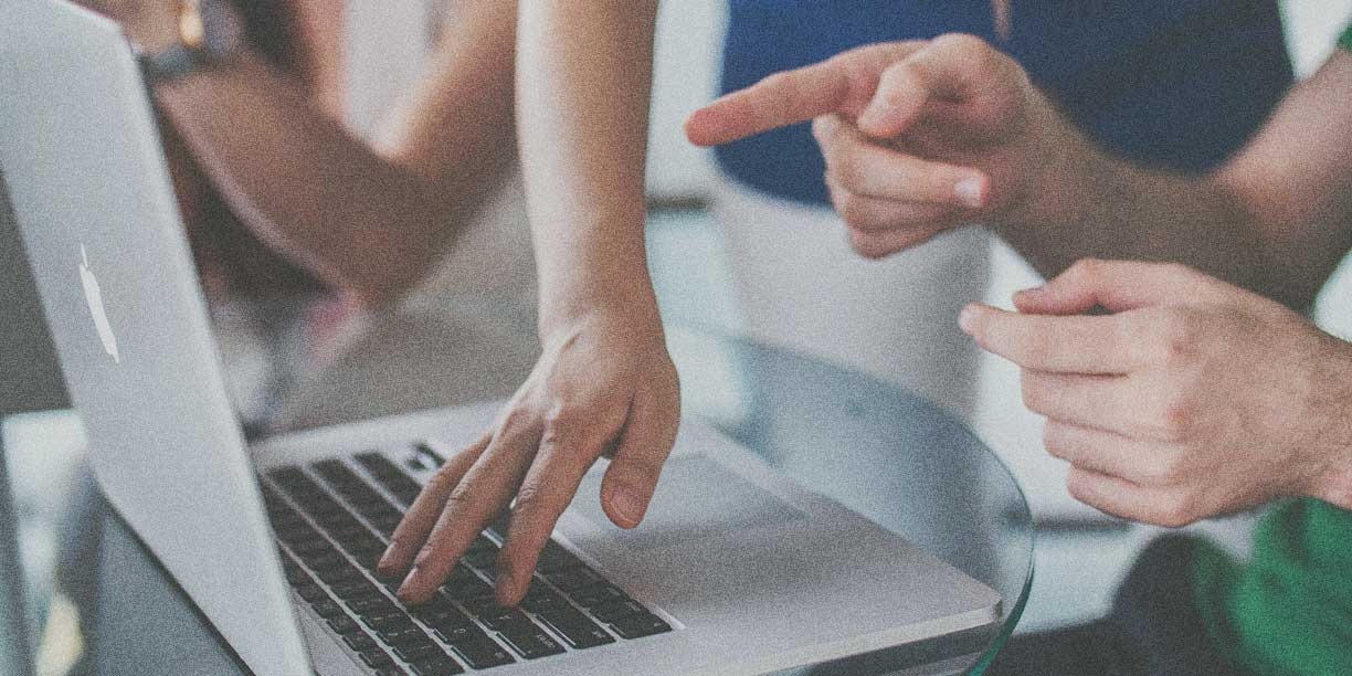 Person's hand on a laptop keyword